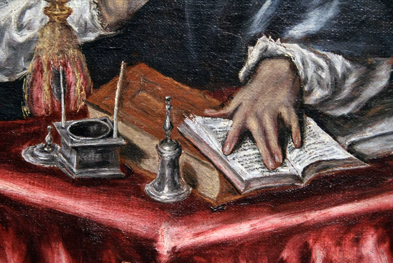 Detail of El Greco’s Saint Jerome, translator of the Vulgate: his hand on an open book beside an inkwell.